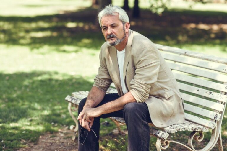pensive-mature-man-sitting-bench-urban-park_1139-1108-860x573